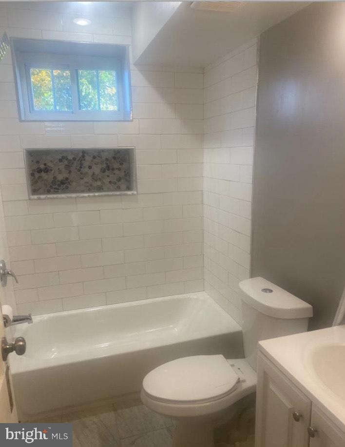 2219 Madison Street, Unit B Chester, PA 19013 - Photo 3 of 5 a white toilet sitting next to a bath tub