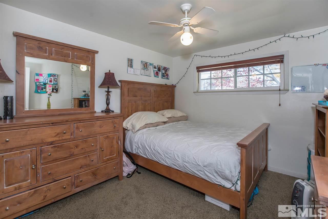 2320 Watt Street Reno, NV 89509 - Photo 12 of 25 a bedroom with a bed and a large mirror on the dresser