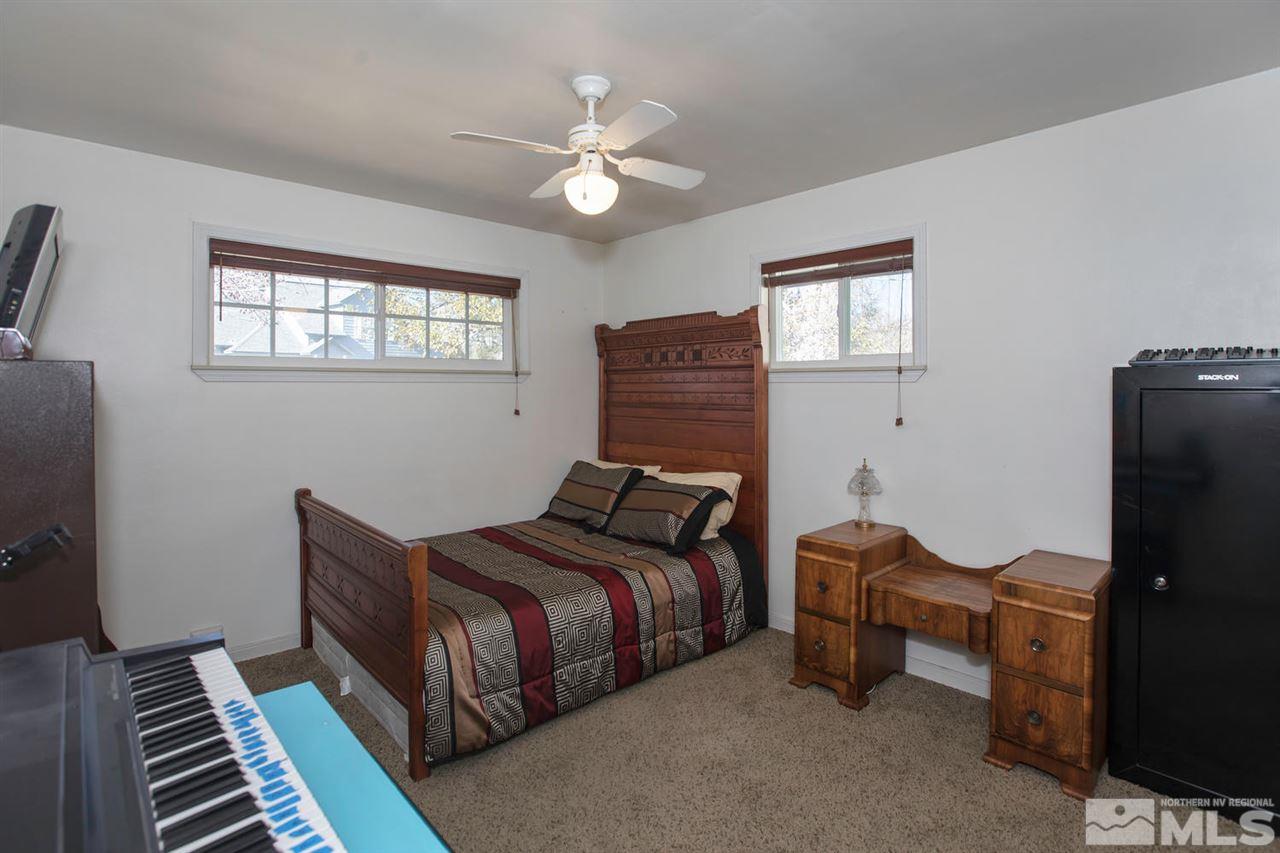 2320 Watt Street Reno, NV 89509 - Photo 13 of 25 a bedroom with a bed and a chandelier