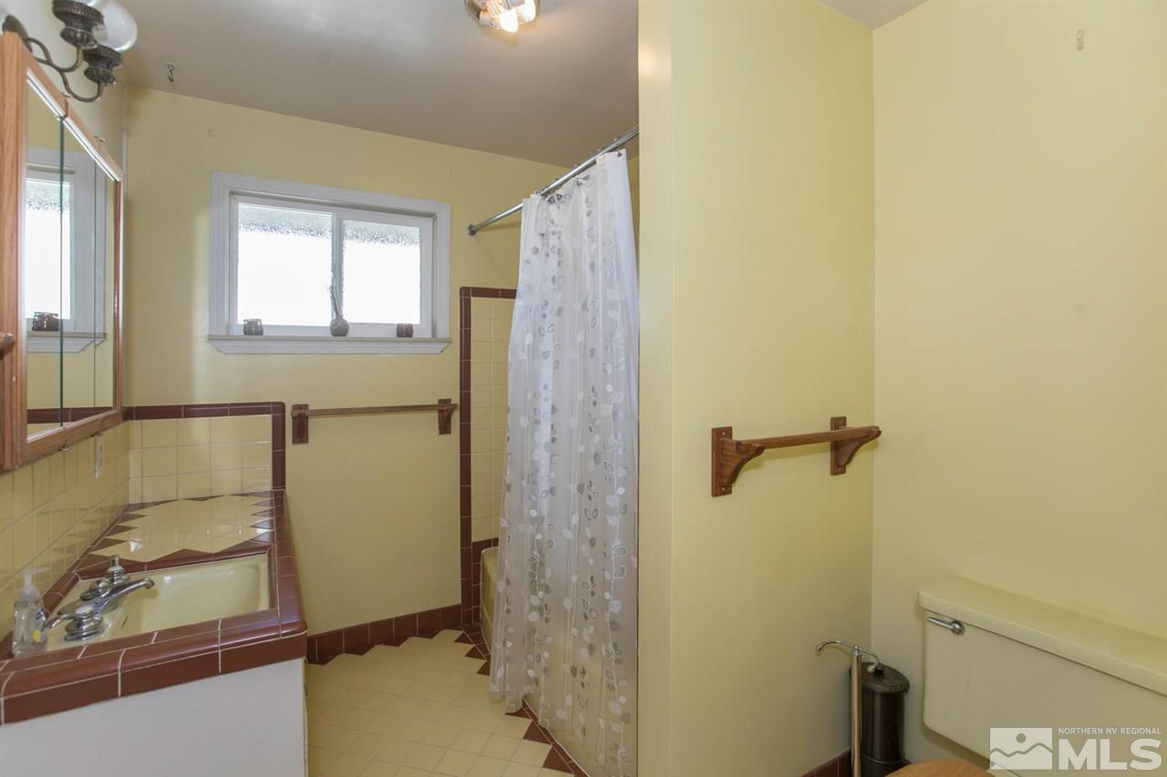 2320 Watt Street Reno, NV 89509 - Photo 14 of 25 a bathroom with a sink and shower