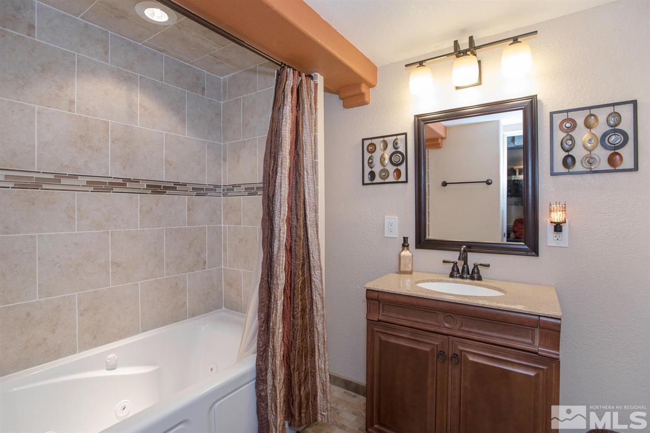 2320 Watt Street Reno, NV 89509 - Photo 18 of 25 a bathroom with a sink a mirror and a bathtub