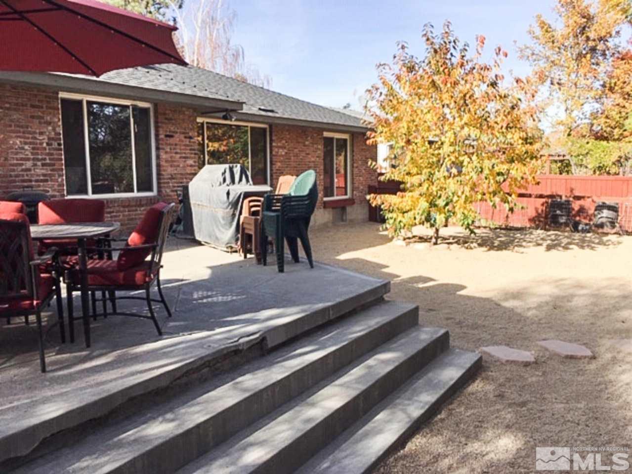 2320 Watt Street Reno, NV 89509 - Photo 22 of 25 a view of a patio with table and chairs with wooden floor and plants