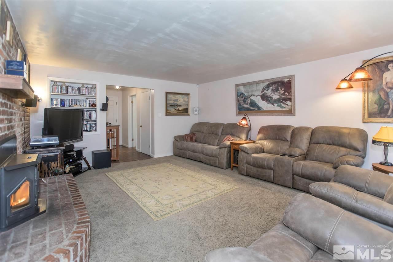 2320 Watt Street Reno, NV 89509 - Photo 3 of 25 a living room with furniture a flat screen tv and a fireplace