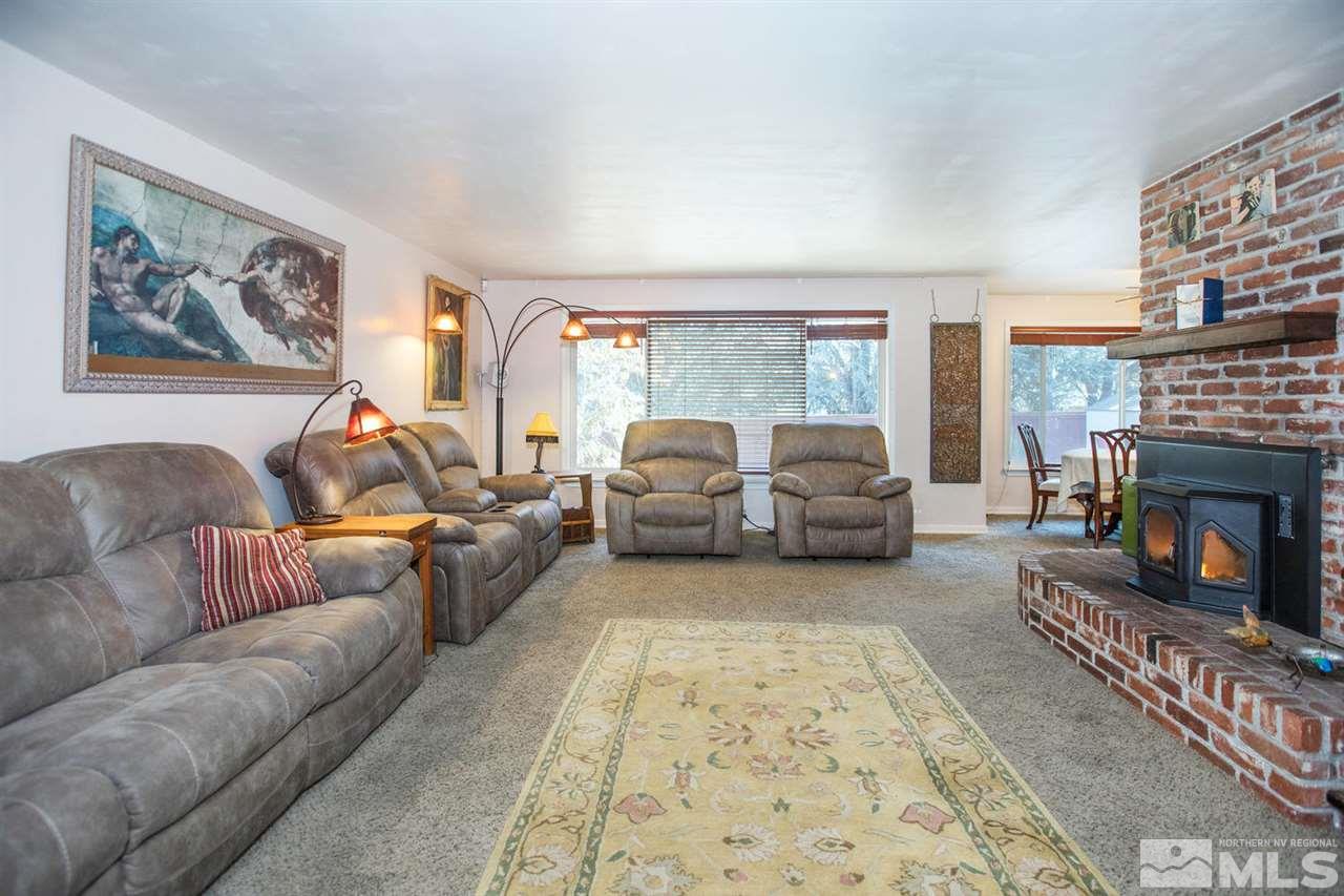 2320 Watt Street Reno, NV 89509 - Photo 4 of 25 a living room with furniture a fireplace and a large window