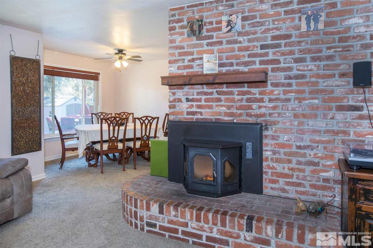 2320 Watt Street Reno, NV 89509 - Photo 5 of 25 a living room with furniture a fireplace and a table