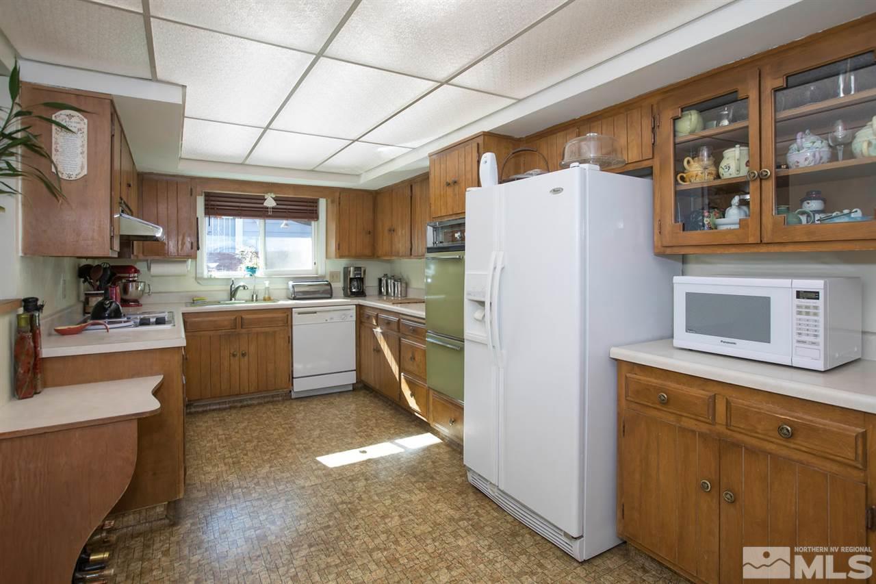 2320 Watt Street Reno, NV 89509 - Photo 6 of 25 a kitchen with a refrigerator a sink and cabinets