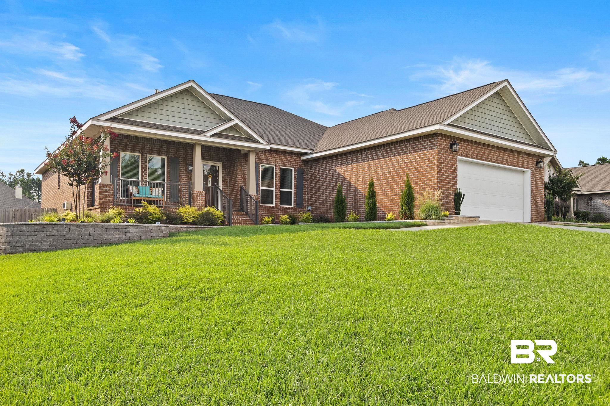 View of front of property featuring a garage and a front yard