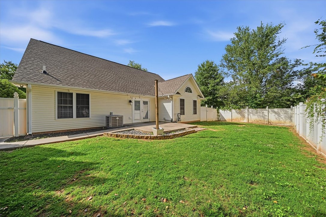 101 Grand Oak Circle Pendleton, SC 29670 - Photo 35 of 40 A well-maintained fenced yard frames a charming home with a cozy patio, perfect for outdoor relaxation.