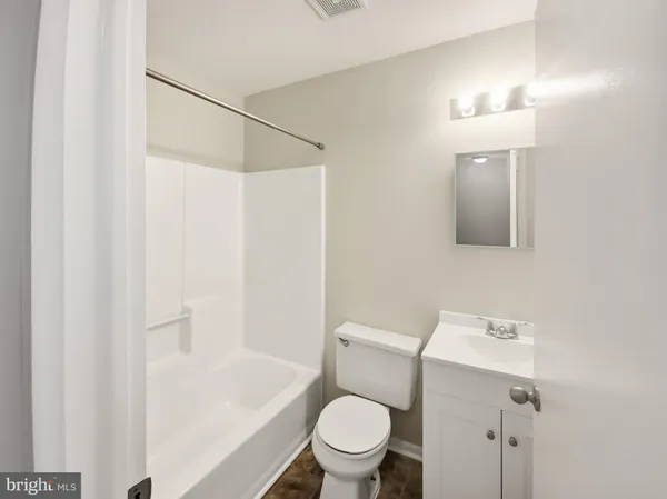 a white toilet sitting next to a bathroom sink