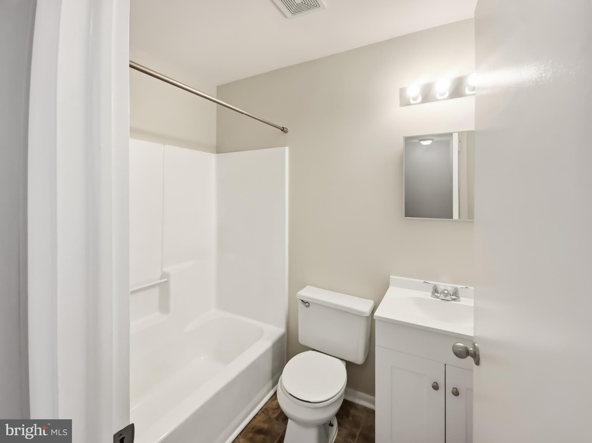 5132 Redbud Road Fredericksburg, VA 22407 - Photo 12 of 19 a white toilet sitting next to a bathroom sink