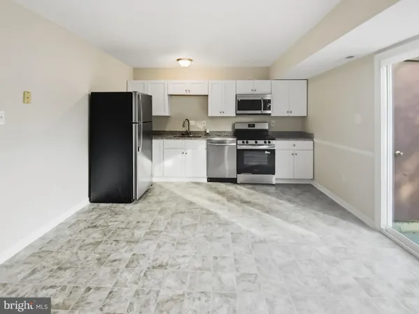 a kitchen with stainless steel appliances granite countertop a refrigerator stove and microwave