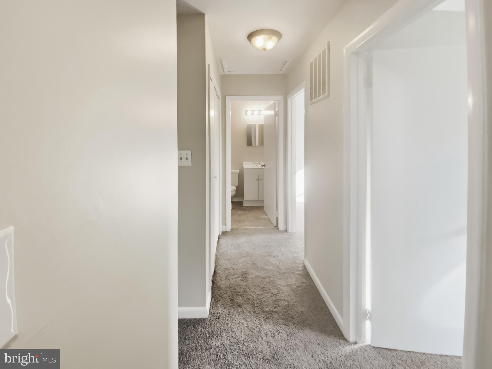 5132 Redbud Road Fredericksburg, VA 22407 - Photo 9 of 19 a view of a hallway with white walls and a window