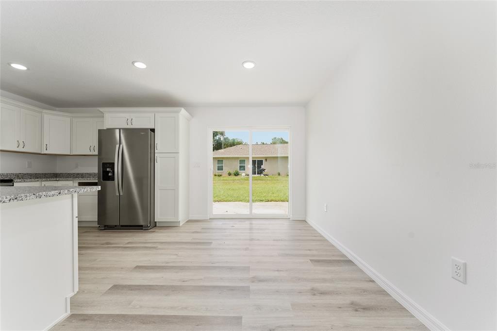 319 Fisher Road Ocklawaha, FL 32179 - Photo 11 of 48 a view of a kitchen with refrigerator and window