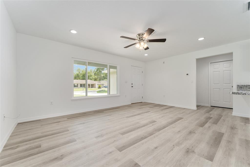 319 Fisher Road Ocklawaha, FL 32179 - Photo 24 of 48 a view of empty room with wooden floor and fan
