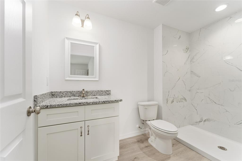 319 Fisher Road Ocklawaha, FL 32179 - Photo 29 of 48 a bathroom with a granite countertop toilet sink and mirror