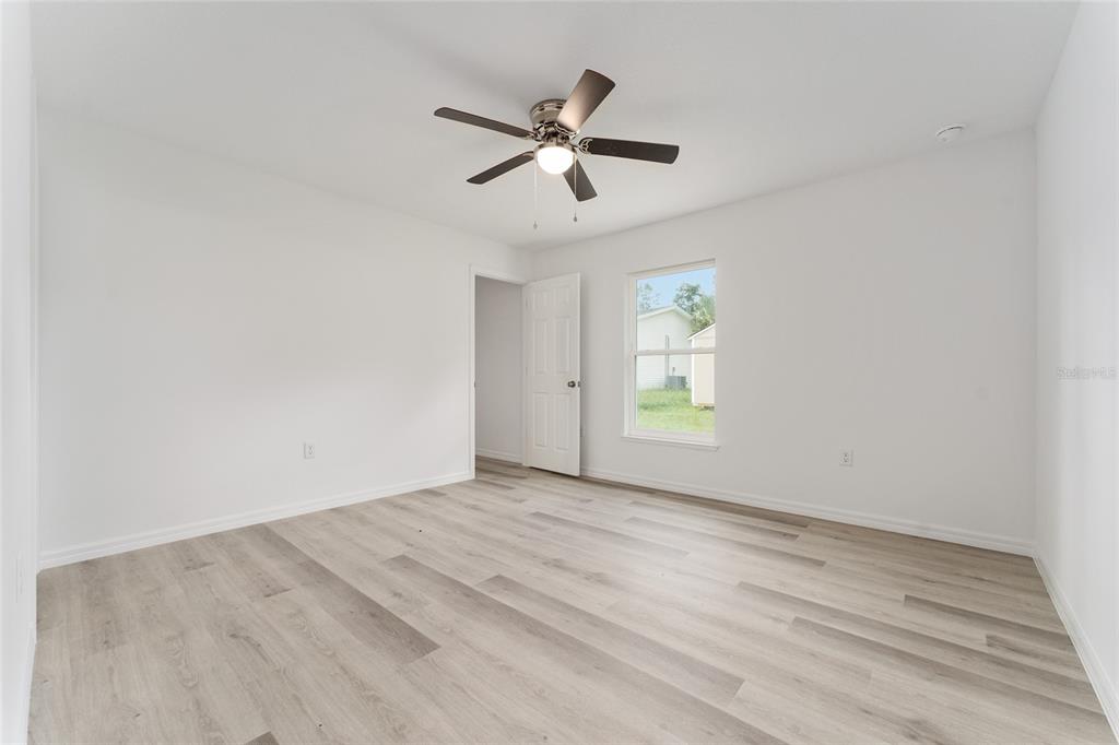 319 Fisher Road Ocklawaha, FL 32179 - Photo 33 of 48 wooden floor in an empty room with a window