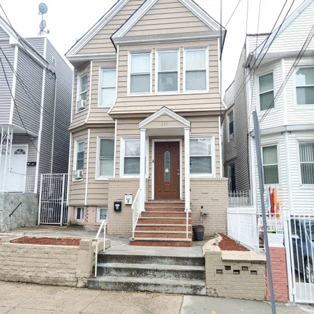 a front view of a house with entryway and stairs