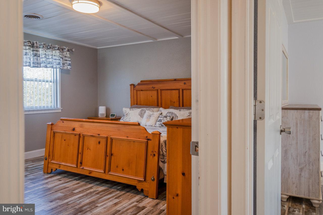 212 Whitacre Road Gore, VA 22637 - Photo 39 of 100 a bedroom with a bed and wooden floor