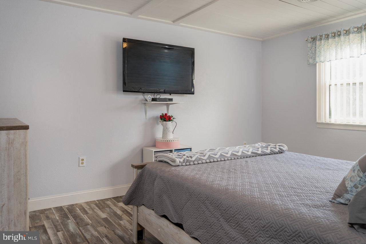 212 Whitacre Road Gore, VA 22637 - Photo 45 of 100 a bedroom with a bed and a flat screen tv