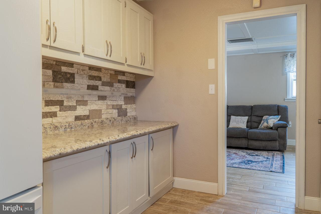 212 Whitacre Road Gore, VA 22637 - Photo 63 of 100 a kitchen with cabinets and a wooden floor