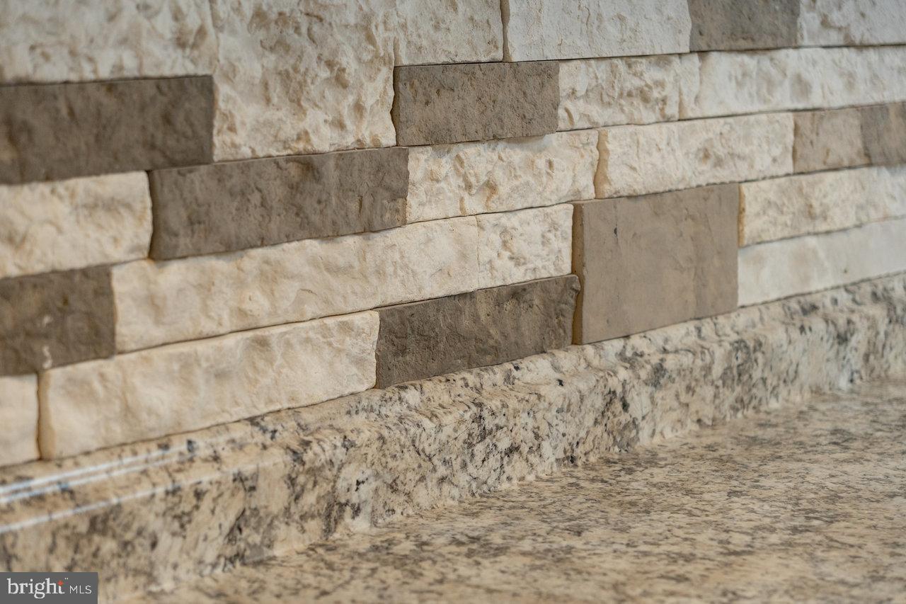 212 Whitacre Road Gore, VA 22637 - Photo 64 of 100 Textured stone wall with elegant granite.