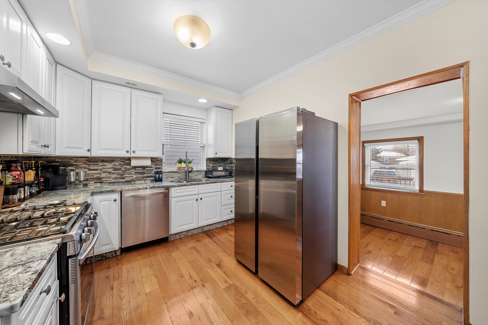 2716 Grove Avenue Berwyn, IL 60402 - Photo 13 of 46 a kitchen with stainless steel appliances granite countertop a refrigerator and a stove top oven