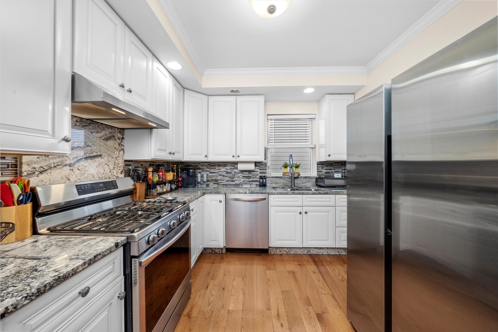 2716 Grove Avenue Berwyn, IL 60402 - Photo 14 of 46 a kitchen with stainless steel appliances granite countertop a stove a sink and a refrigerator
