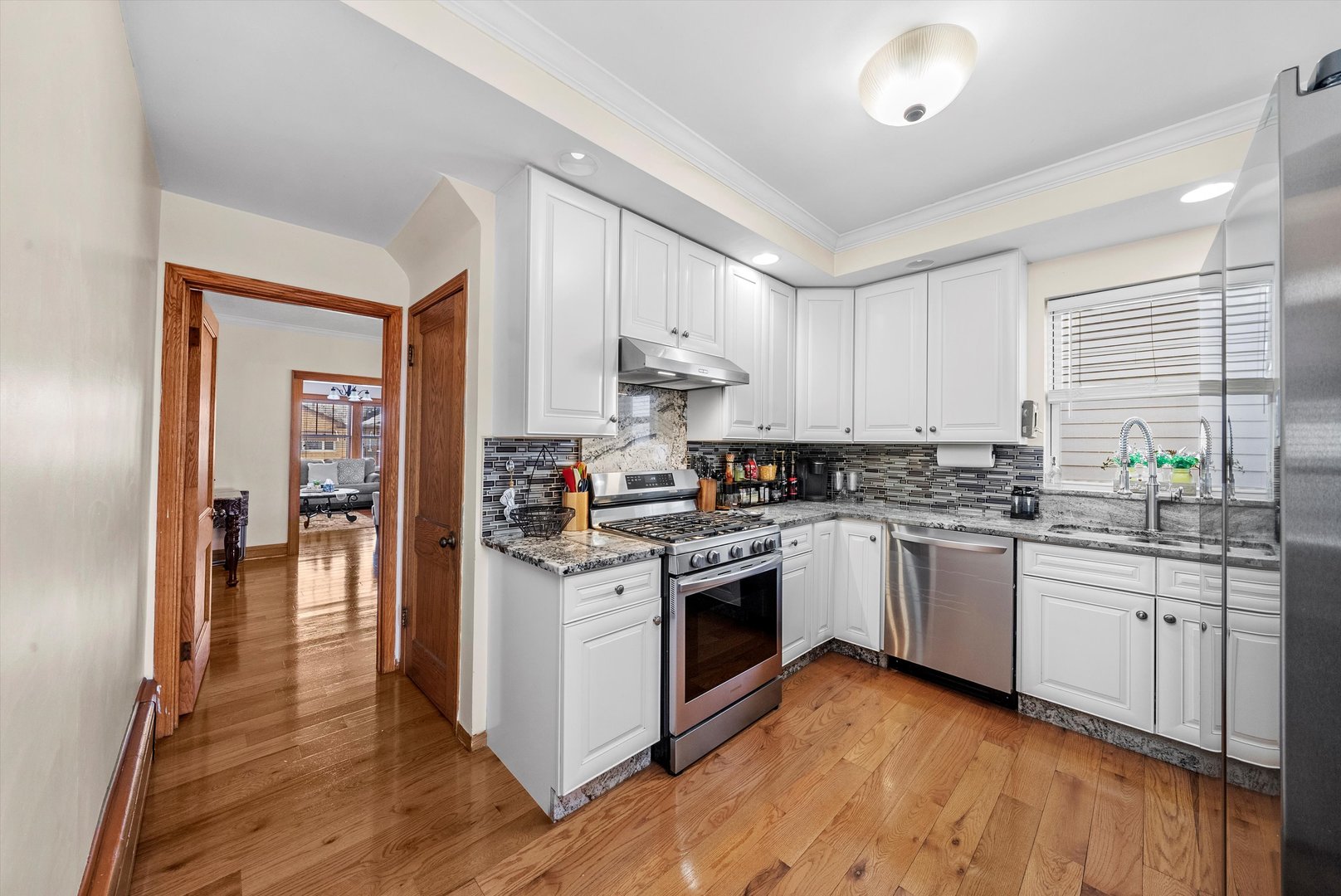 2716 Grove Avenue Berwyn, IL 60402 - Photo 15 of 46 a kitchen with stainless steel appliances granite countertop a stove and cabinets