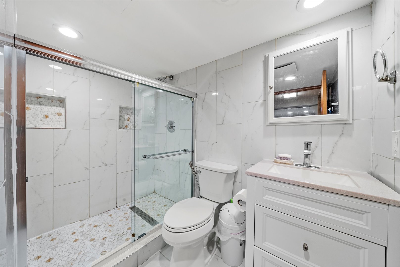 2716 Grove Avenue Berwyn, IL 60402 - Photo 25 of 46 a bathroom with a sink toilet vanity and shower