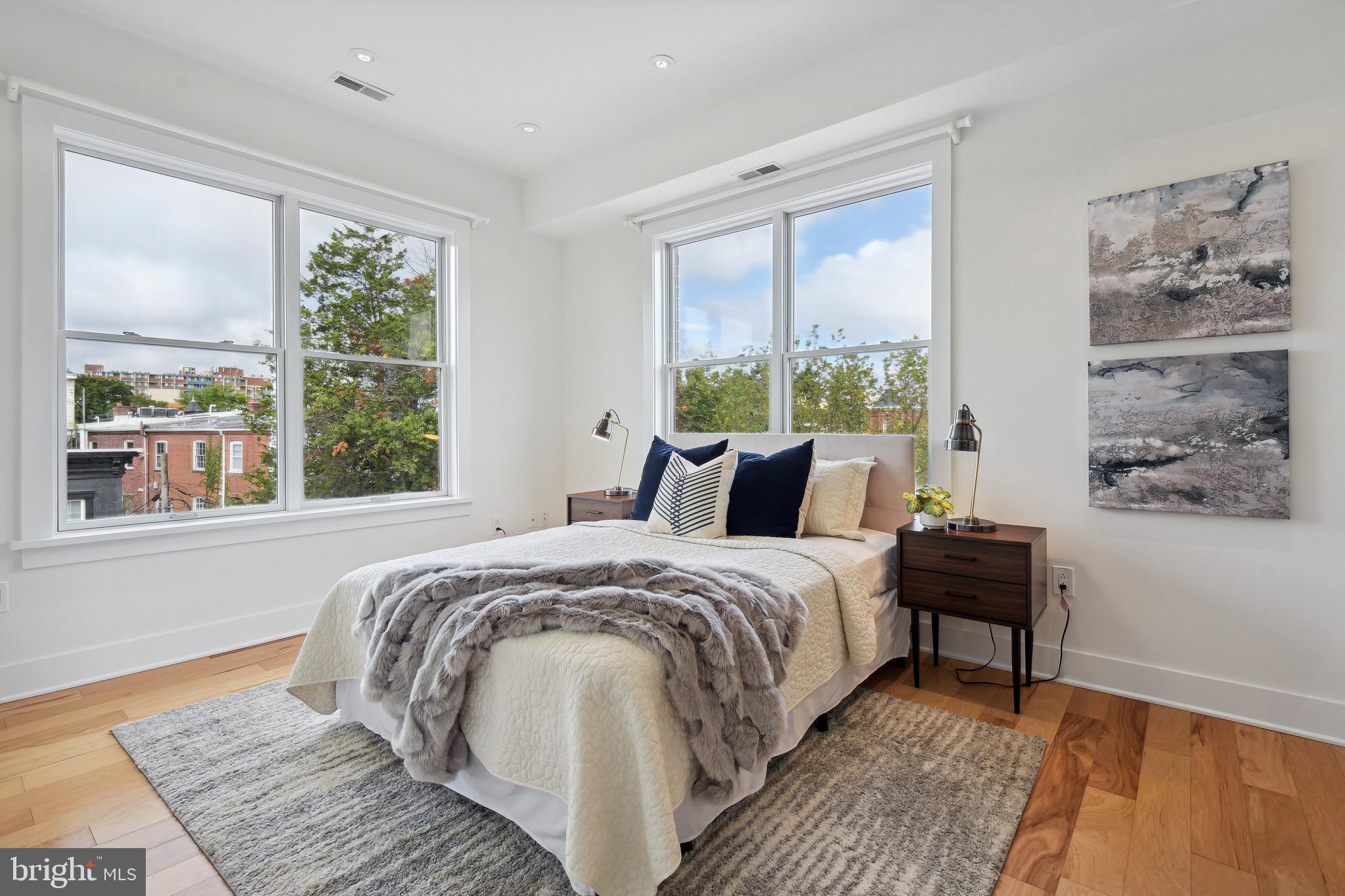 449 R Street Northwest, Unit 301 Washington, DC 20001 - Photo 11 of 29 a bed sitting in a bedroom next to a window