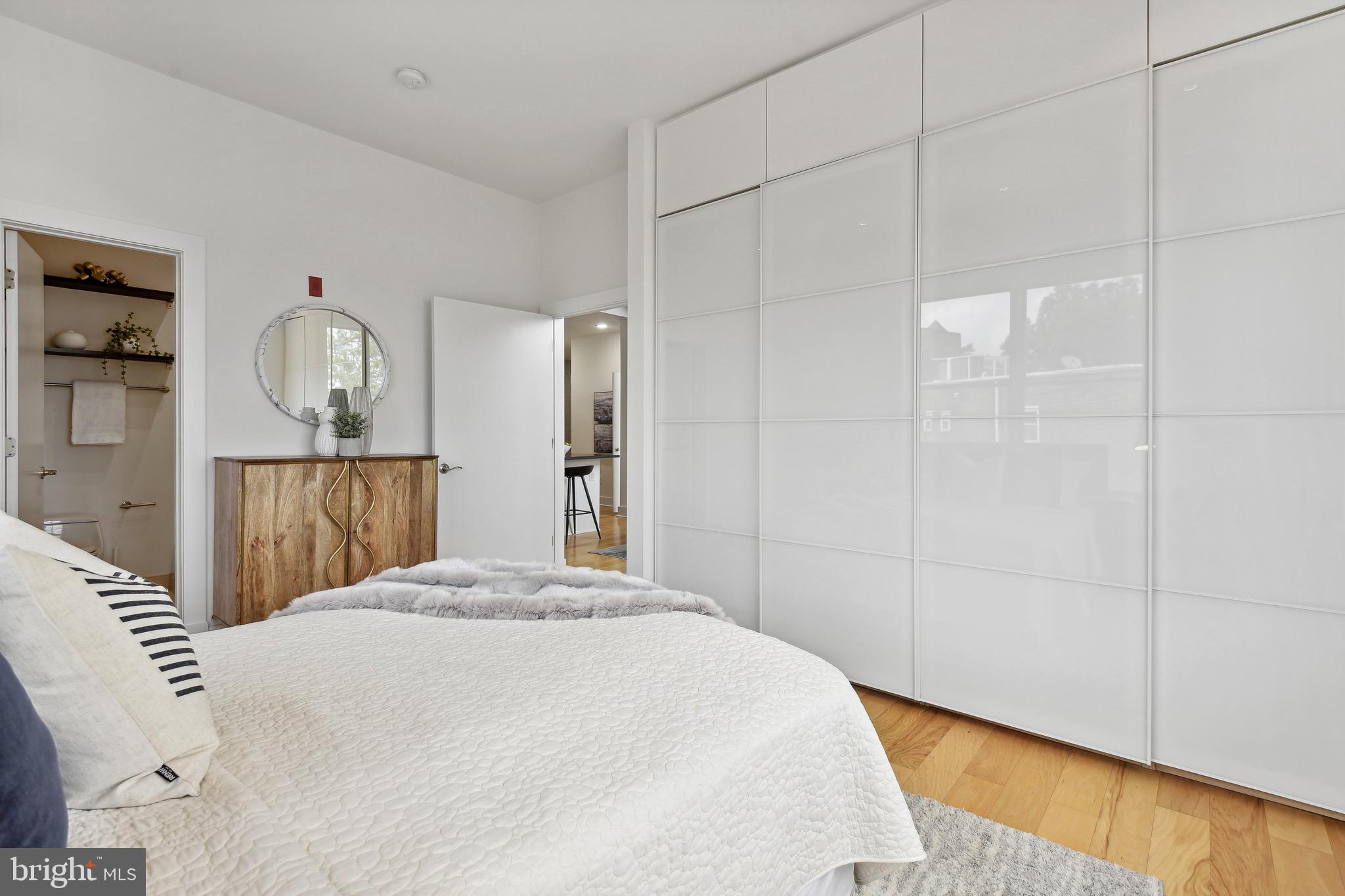 449 R Street Northwest, Unit 301 Washington, DC 20001 - Photo 12 of 29 a bedroom with a bed and a mirror