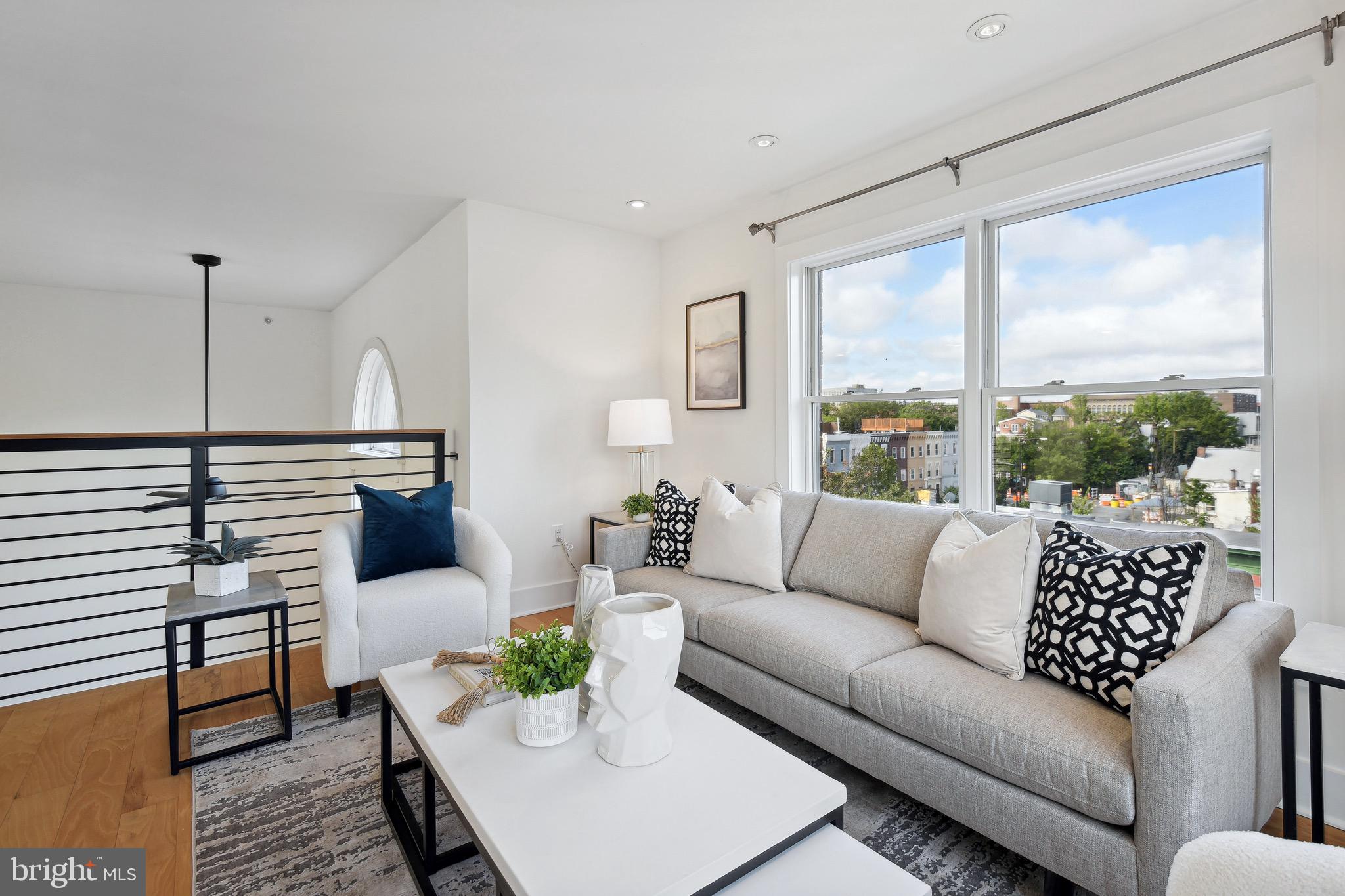 449 R Street Northwest, Unit 301 Washington, DC 20001 - Photo 21 of 29 a living room with furniture and a large window
