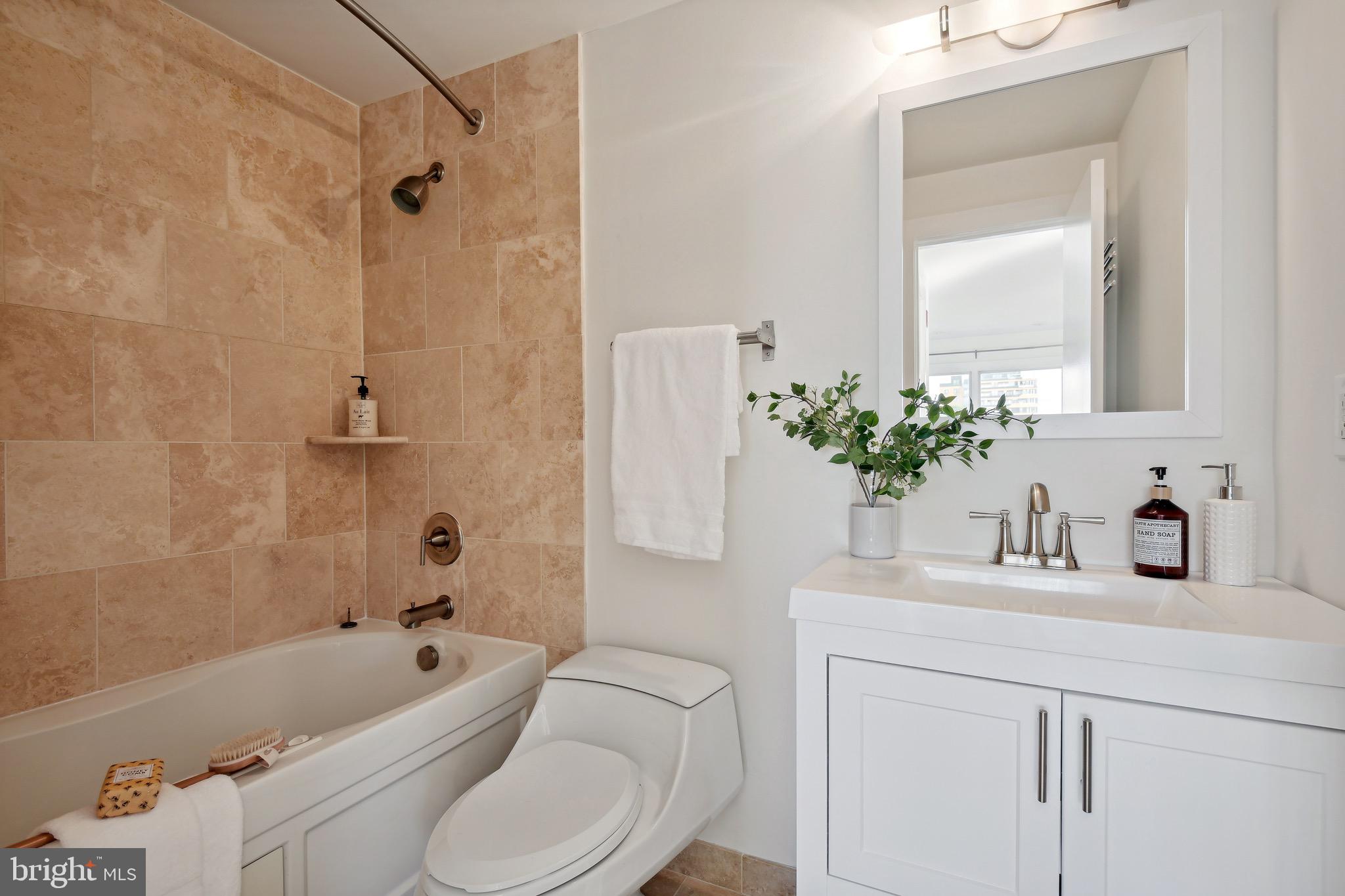 449 R Street Northwest, Unit 301 Washington, DC 20001 - Photo 23 of 29 a bathroom with a sink a toilet a mirror a vanity and shower