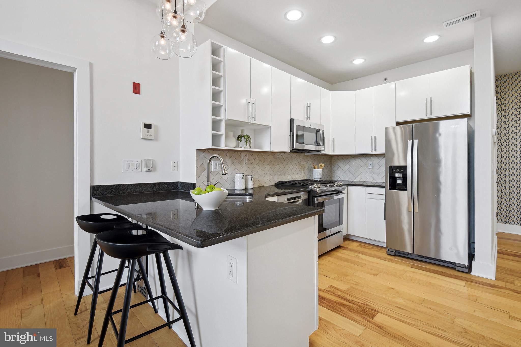 449 R Street Northwest, Unit 301 Washington, DC 20001 - Photo 5 of 29 a kitchen with stainless steel appliances granite countertop a sink stove and refrigerator