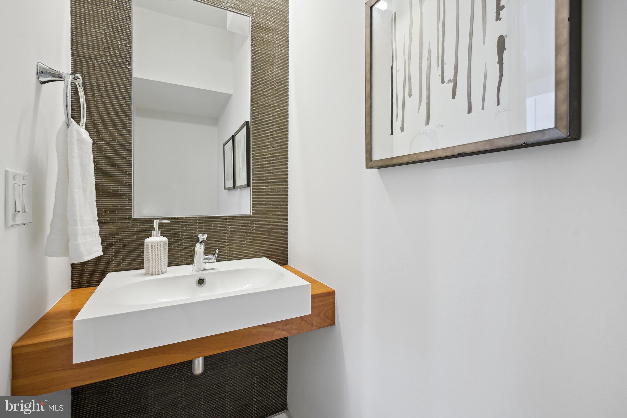 449 R Street Northwest, Unit 301 Washington, DC 20001 - Photo 7 of 29 a bathroom with a sink and a mirror