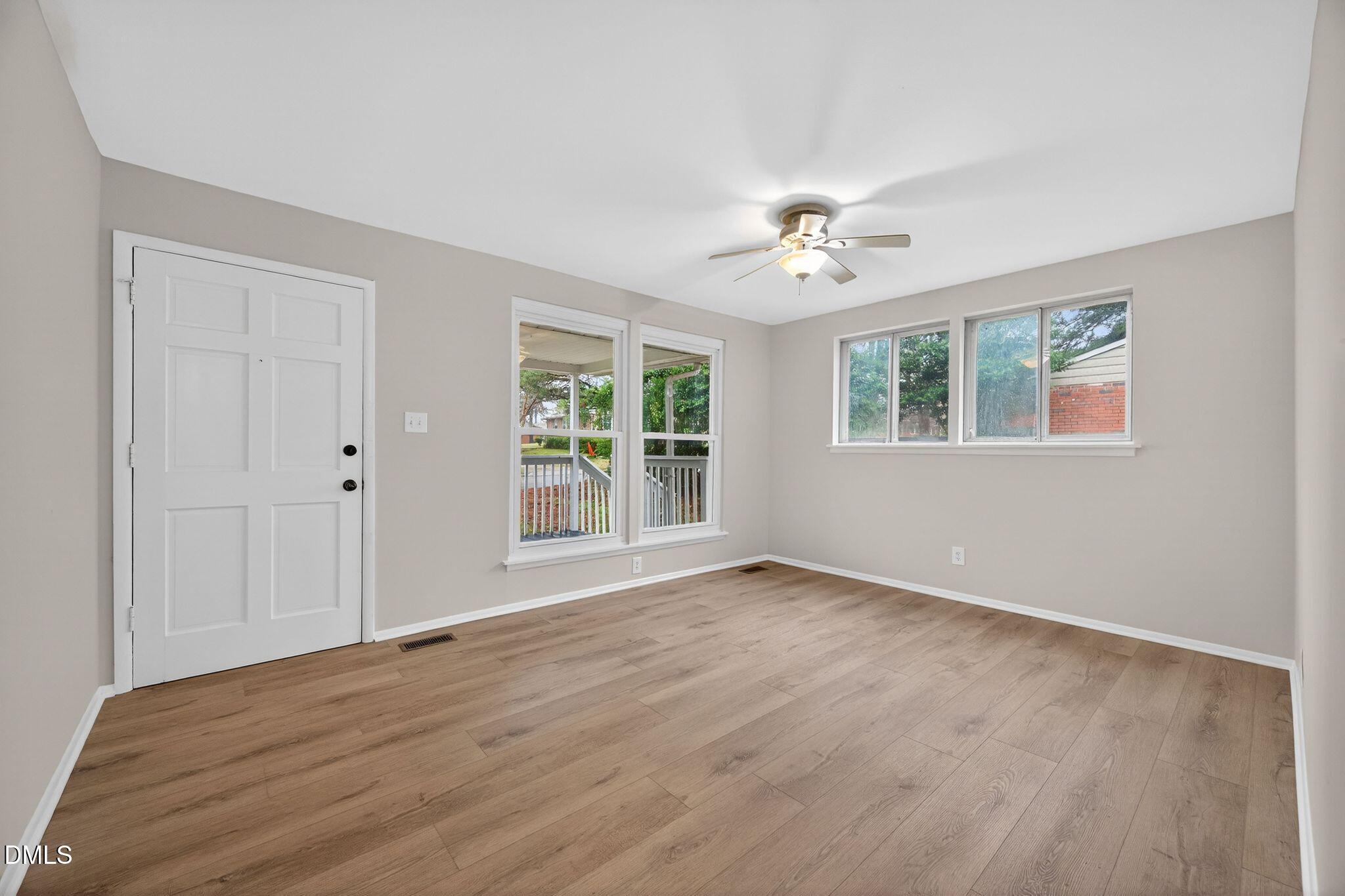 765 Bunche Drive Raleigh, NC 27610 - Photo 11 of 24 a view of an empty room with a window and wooden floor
