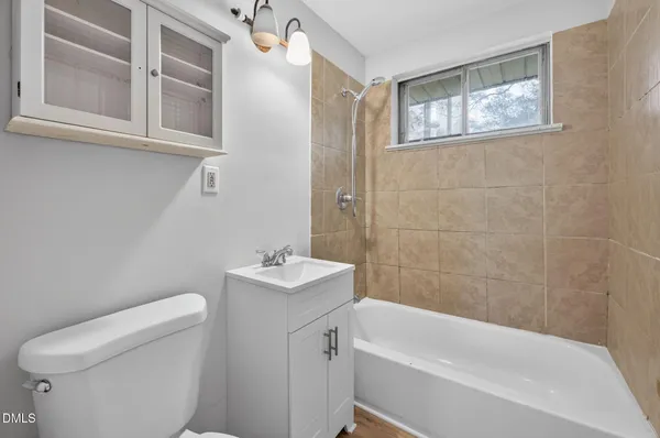 a bathroom with a toilet a sink and bathtub