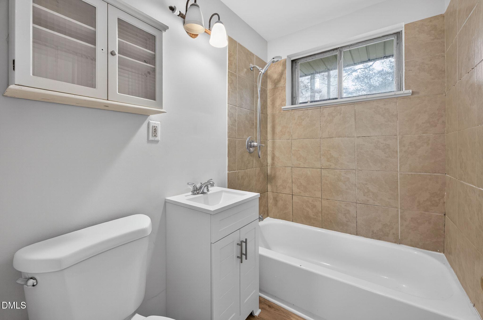 765 Bunche Drive Raleigh, NC 27610 - Photo 16 of 24 a bathroom with a toilet a sink and bathtub