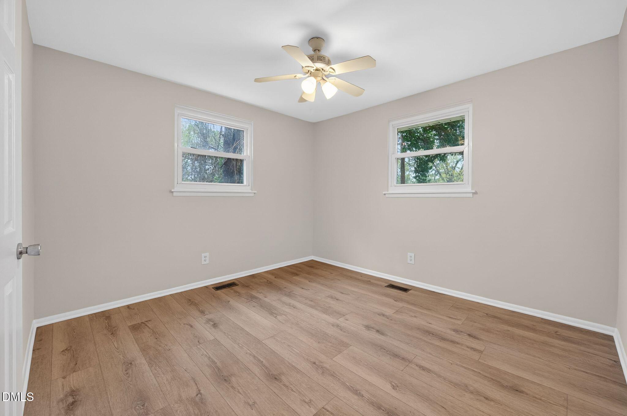 765 Bunche Drive Raleigh, NC 27610 - Photo 18 of 24 wooden floor in an empty room with a window