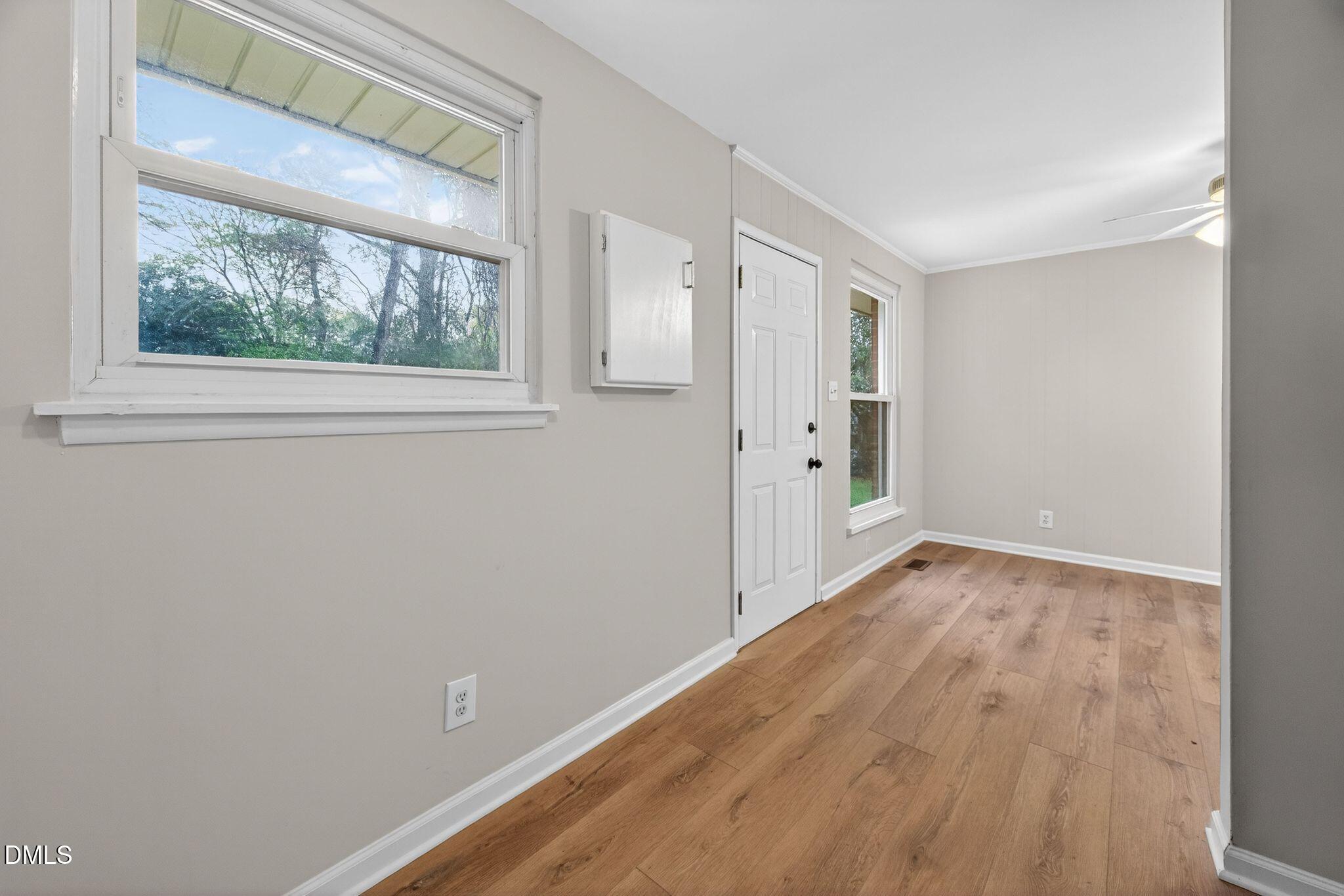 765 Bunche Drive Raleigh, NC 27610 - Photo 24 of 24 a view of an empty room with wooden floor and a window