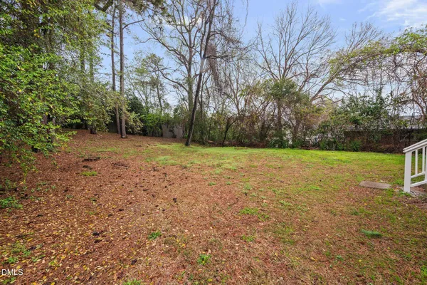 a view of a field with trees in the background