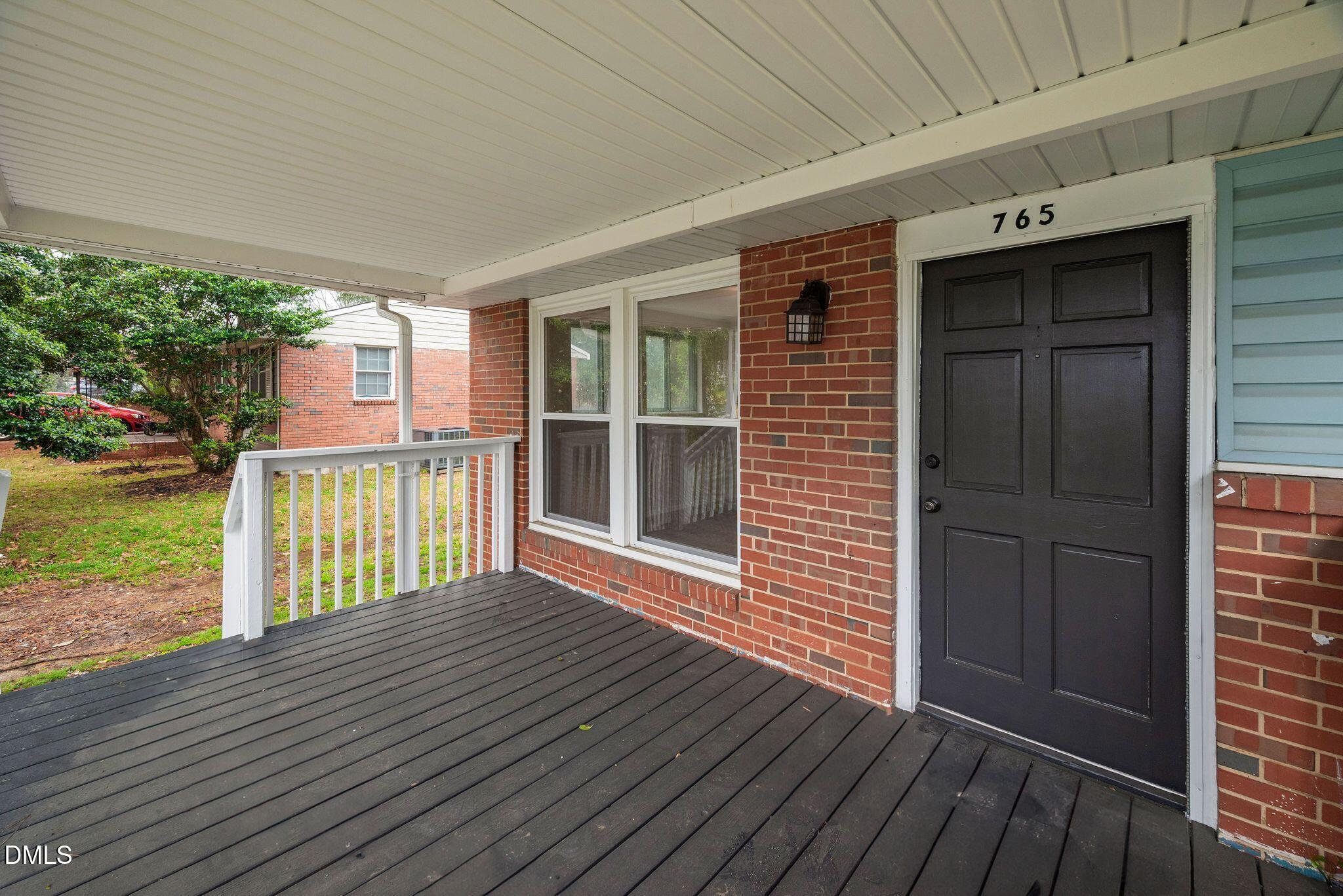 765 Bunche Drive Raleigh, NC 27610 - Photo 5 of 24 a view of backyard with deck and floor to ceiling window