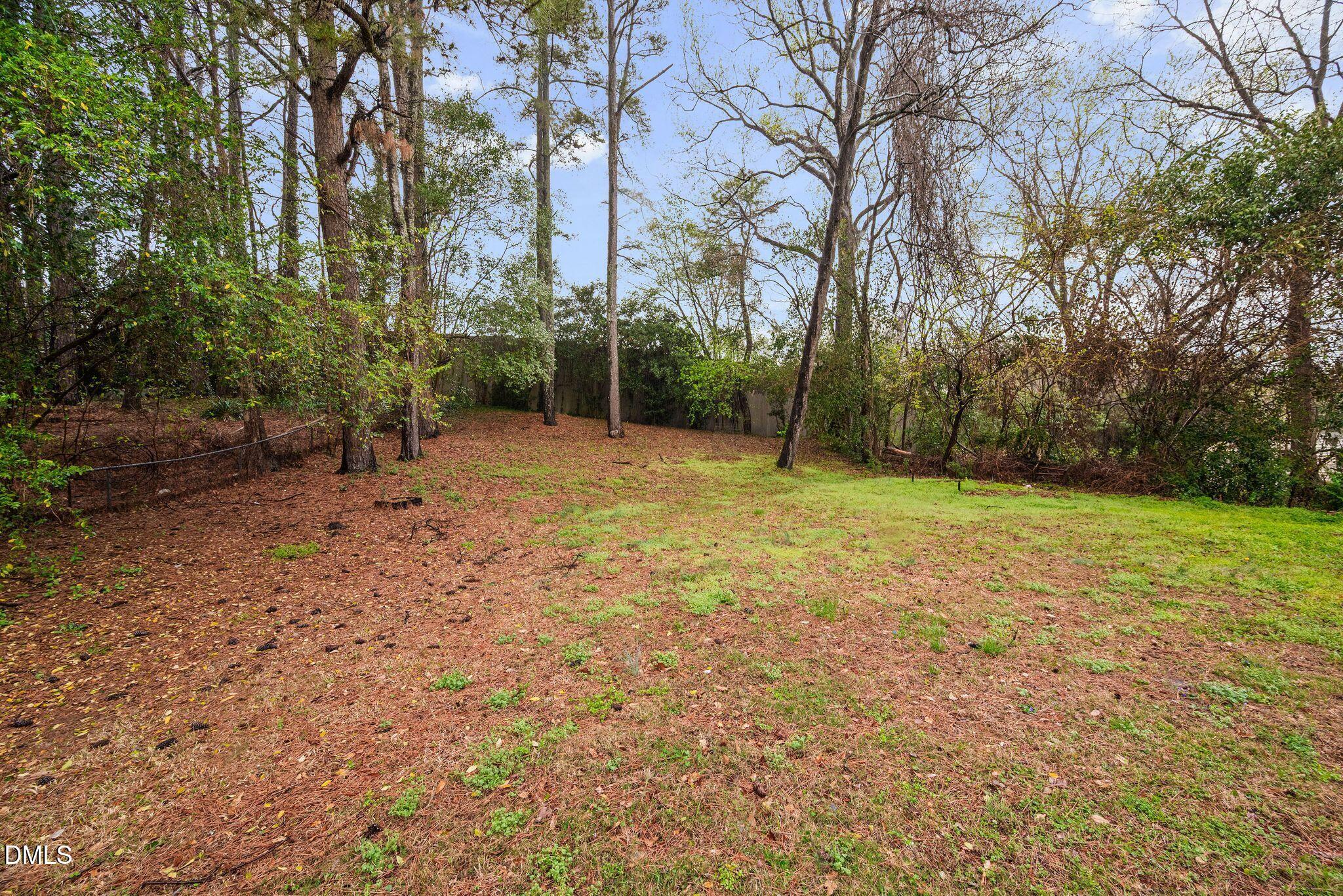 765 Bunche Drive Raleigh, NC 27610 - Photo 7 of 24 a view of a field with trees in the background