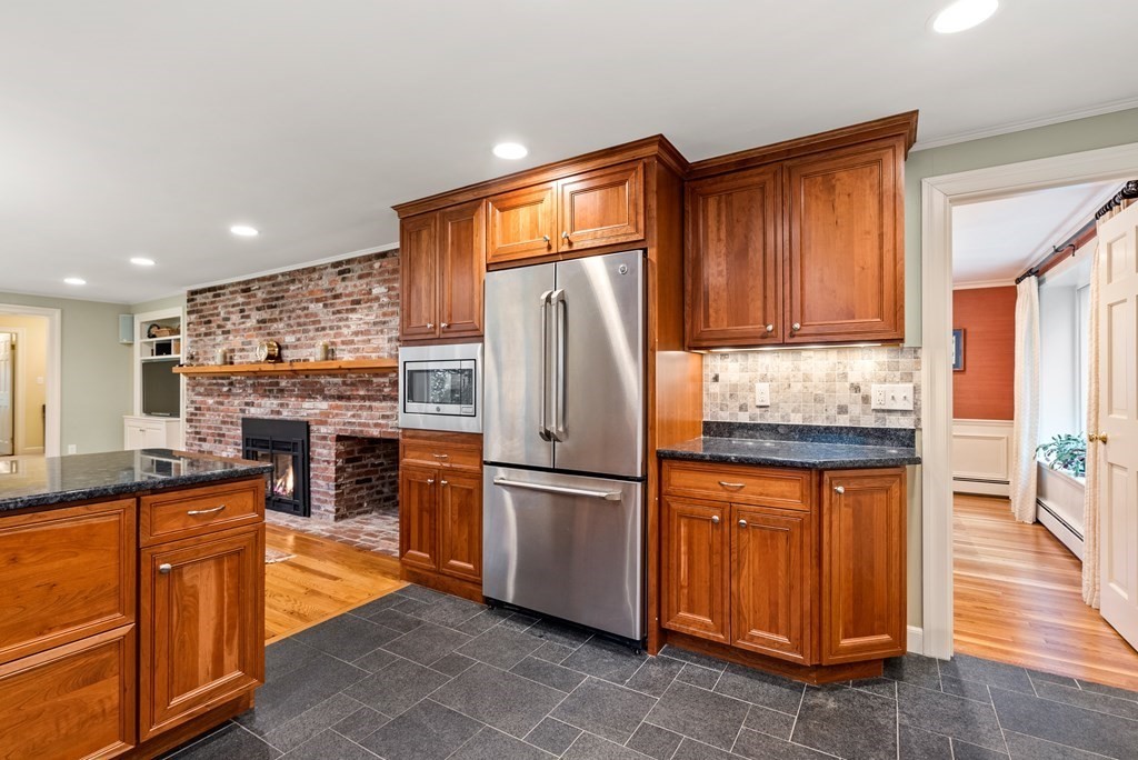 70 Cherry Brook Road Weston, MA 02493 - Photo 11 of 32 a kitchen with granite countertop stainless steel appliances and wooden cabinets