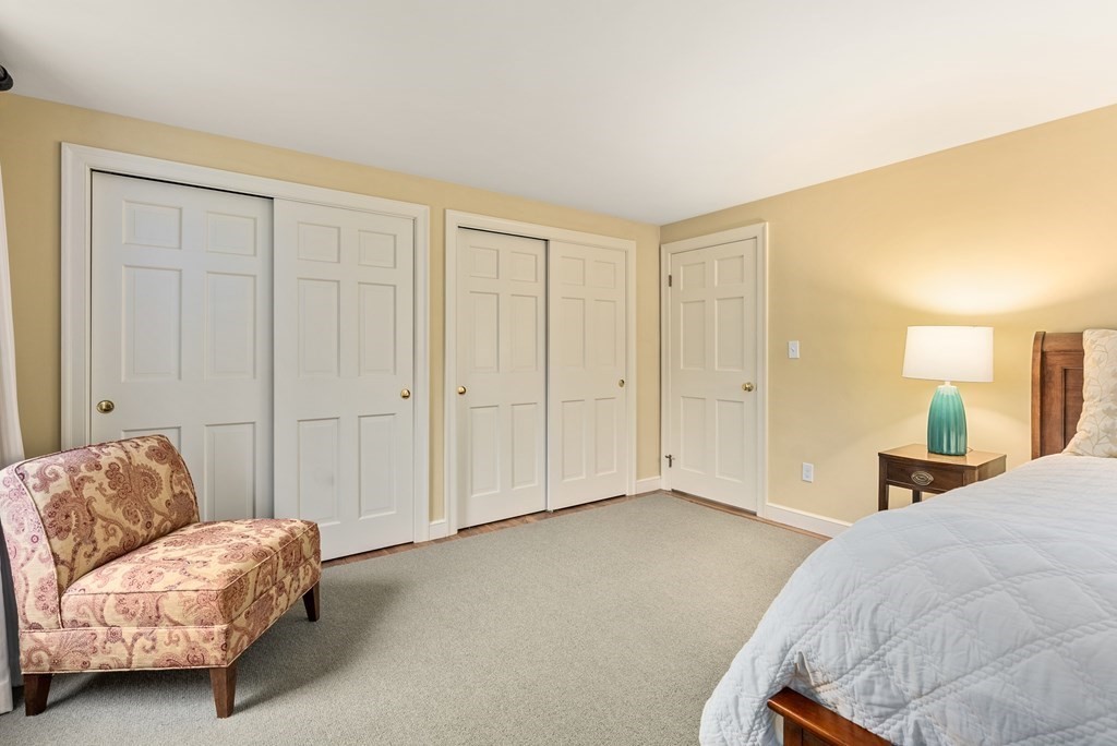 70 Cherry Brook Road Weston, MA 02493 - Photo 19 of 32 a spacious bedroom with a bed and a couch