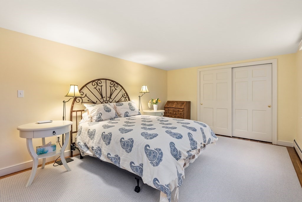 70 Cherry Brook Road Weston, MA 02493 - Photo 24 of 32 a bedroom with a bed and a chair