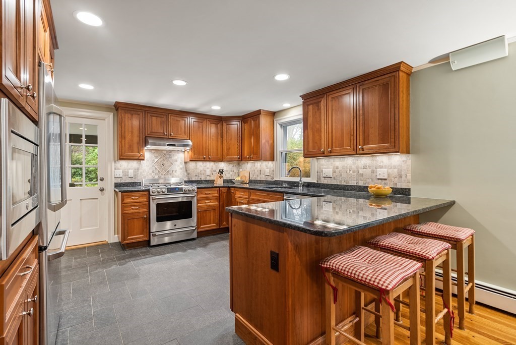 70 Cherry Brook Road Weston, MA 02493 - Photo 10 of 32 a kitchen with stainless steel appliances granite countertop a stove sink and cabinets