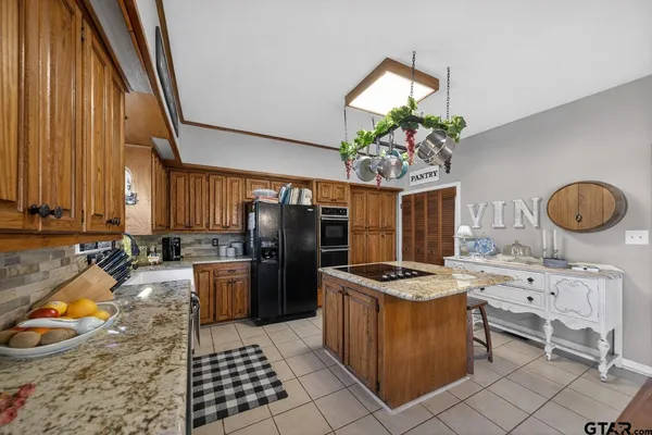 a kitchen with a stove a refrigerator and a dining table