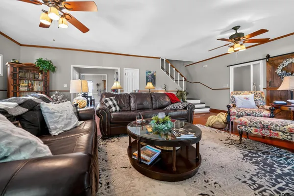 a living room with furniture a rug and a chandelier