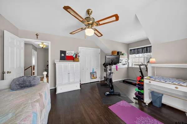 a room with gym equipment and a wooden floor